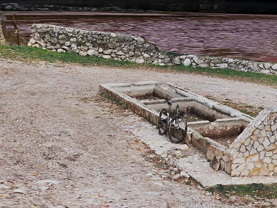 Natural Outdoor Scene With Stone Troughs Bicycle Gravel Ground And Distant Water 3d model