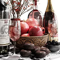 Wine Bottles and Wine Glasses with Pomegranates Macarons Berries and Decorative Flowers