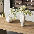 Elegant White Textured Vases With White Hydrangea Flowers On Wooden Table