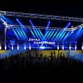 Nighttime Concert Stage With Bright Stage Lights Truss Structure And Cheering Audience