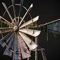 Rusted Windmill Equipment With Metal Blades Moss Growth And Wooden Stand