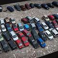 Parking Lot Full of Various Colored Cars And Different Vehicle Models Densely Parked