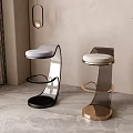 Modern Bar Stools With Black And Gold Metal Frames Upholstered Seats Gray Floor And Plant