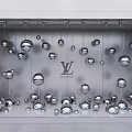 Louis Vuitton Window Display with Hanging Silver Spheres and Artistic Arrangement Design