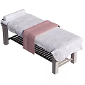 Comfortable Massage Table With Gray Mattress Pink Towel And Metal Frame