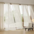 Beige Curtains by Window with Trees Outside and Cozy Chair with Floor Lamp