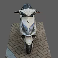 White And Black Electric Scooter With Black Seat Parked On Brick Pavement