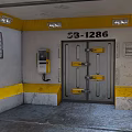 Industrial Metal Security Door With Number 531286 Yellow Latches And Gray Walls