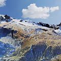 Breathtaking Mountain Landscape With Snow Covered Peaks Blue Sky And White Clouds Scenic View