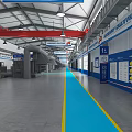 Industrial Factory Interior With Red Overhead Cranes Blue Floor Markings Equipment And Signage