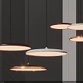Modern Minimalist Pendant Lights With Circular Design Illuminated On Dark Striped Wall