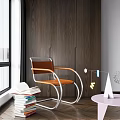 Modern Leisure Chair with Brown Seat Metal Frame near Stack of Books and Pink Table