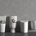 Different Styles Of White Toilets With Grey Marble Wall And Bathroom Toiletries On Top