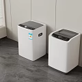 Two Modern White Washing Machines In Laundry Room With Gray Floor And White Walls