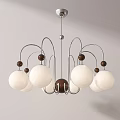 Modern Chandelier With Silver Metal Arms And Multiple White Globe Shades For Home Decor