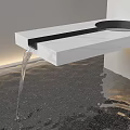 Indoor Landscape Featuring White Marble Countertop Black Circular Sink Flowing Water Dark Floor Soft Lighting
