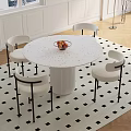 Modern Round Marble Table With White Chairs Black Armrests And Snowy Window View