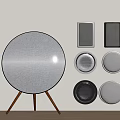 Round Gray Speaker on Wooden Stand with Wall Mounted Speakers Various Shapes Colors