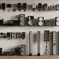 Various Types of Headphones and Audio Speakers Neatly Arranged on Wall and Floor