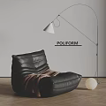 Black Leather Single Sofa with Brown Blanket Floor Lamp White Sphere Decoration on Wooden Floor