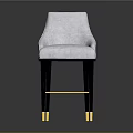 Light Colored Upholstered Bar Stool With Black Legs And Gold Accents