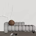 Light Gray Rounded Tufted Chaise Lounge With Brown Textured Pillow And White Textured Wall