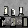 Outdoor Lamps With Modern Geometric Cutout Patterns And Metal Frames Displayed On Stone Surface