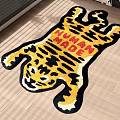 Vibrant Tiger Shaped Rug with HUMAN MADE Lettering on Wooden Floor