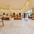 Dessert Shop Interior With Sweet Treats Display Shelves Cozy Seating And Bright Lighting Design
