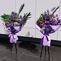 Elegant Floral Display With Purple Wrapped Bouquets On Black Tripods Against White Wall