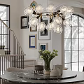 Modern Glass Globe Chandelier Above Dining Table with Staircase and Wall Art