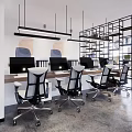 Modern Public Office Space With Ergonomic Chairs Desks Computer Monitors Plants Artworks And Metal Frames