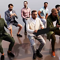 Group of Men in Various Outfits Interacting with Wine Glasses and Laptop in Open Space