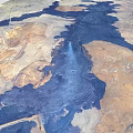 3D Terrain Model Featuring Brown Yellow Land Blue Water Areas And Linear Paths