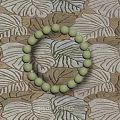 Light Green Beaded Bracelet on Patterned Fabric with Leaf Motifs 3d model