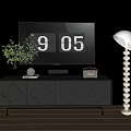 Black TV Stand With Carved Drawers Green Plant Clock Radio And White Floor Lamp