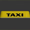Yellow Taxi Roof Sign with Black TAXI Lettering and Reflection Effect on Dark Background