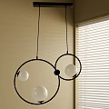 Modern Circular Chandelier with Black Rings and White Globes with Beige Wall and Window Blinds