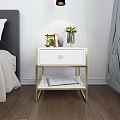 Modern White Bedside Table With Gold Frame One Drawer And Open Book On Lower Shelf