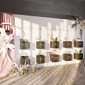 Commercial Display Equipment With Black Square Boxes And Floral Decorations On White Wall