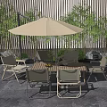 Outdoor Dining Set with Umbrella and Wooden Wall Surrounded by Green Plants in Patio Area