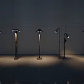 Modern Floor Lamps With Various Designs Metal Stands And Illuminated Shades Against Minimalist Wall