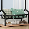 Black Metal Clothes Rack with Hanging Checkered Towels and Potted Plant
