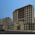Modern Hotel Building Exterior With Illuminated Windows Entrance And Surrounding Buildings At Evening