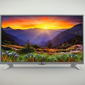 LG TV Displaying Beautiful Sunset Over Mountain Meadow With Purple Flowers