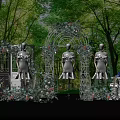 Mannequins In White Dresses With Decorative Arch Floral Decor And Green Tree Background
