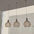 Three Modern Pendant Lights With Woven Design Hanging In Interior Space