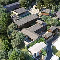 Traditional Modern Guesthouse Architecture with Sloped Wooden Roofs and Lush Green Surroundings