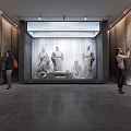 Modern Exhibition Hall Featuring Classical Statues And Visitors Viewing Artworks In Spacious Interior