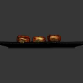 Three Roasted Pork Belly Skewers On Black Slate Plate With Glossy Surface